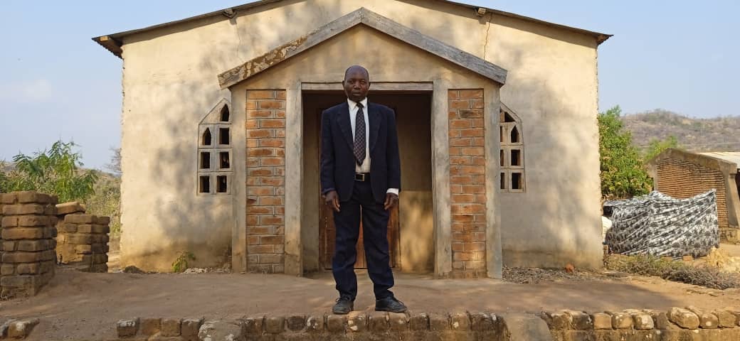 Pastor Gama standing in front of his church